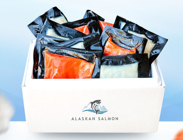 Vacuum-sealed salmon portions packed in a white box labeled ALASKAN SALMON
