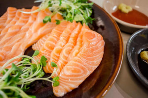 slices of raw salmon in brown plate