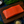 Top-down view of Wild Alaskan Coho salmon fillet showing vibrant orange flesh and marbling on a dark cutting board with lemon