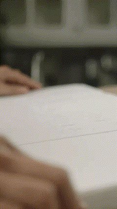Hands opening a white insulated shipping box packed with dry ice