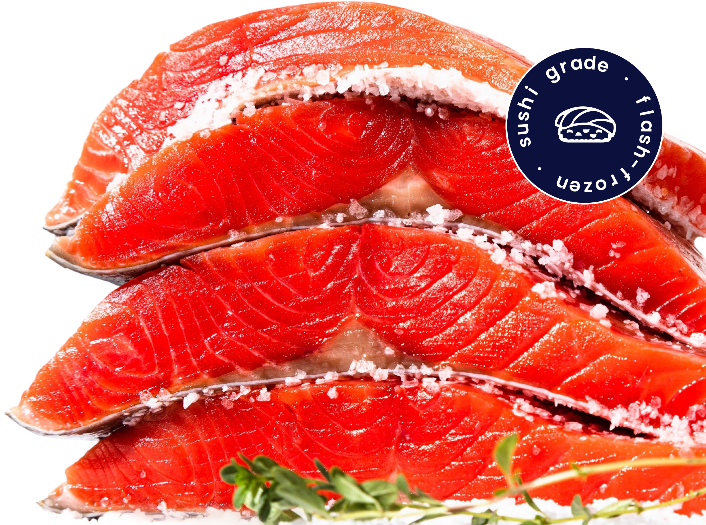 Three slices of raw salmon sprinkled with coarse salt and a herb sprig, with a circular label reading 'sushi grade flash frozen' and a sushi icon.