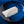 Top-down view of Wild Alaskan black cod (sablefish) fillets, skinless, showcasing glossy raw flesh on a blue ceramic plate